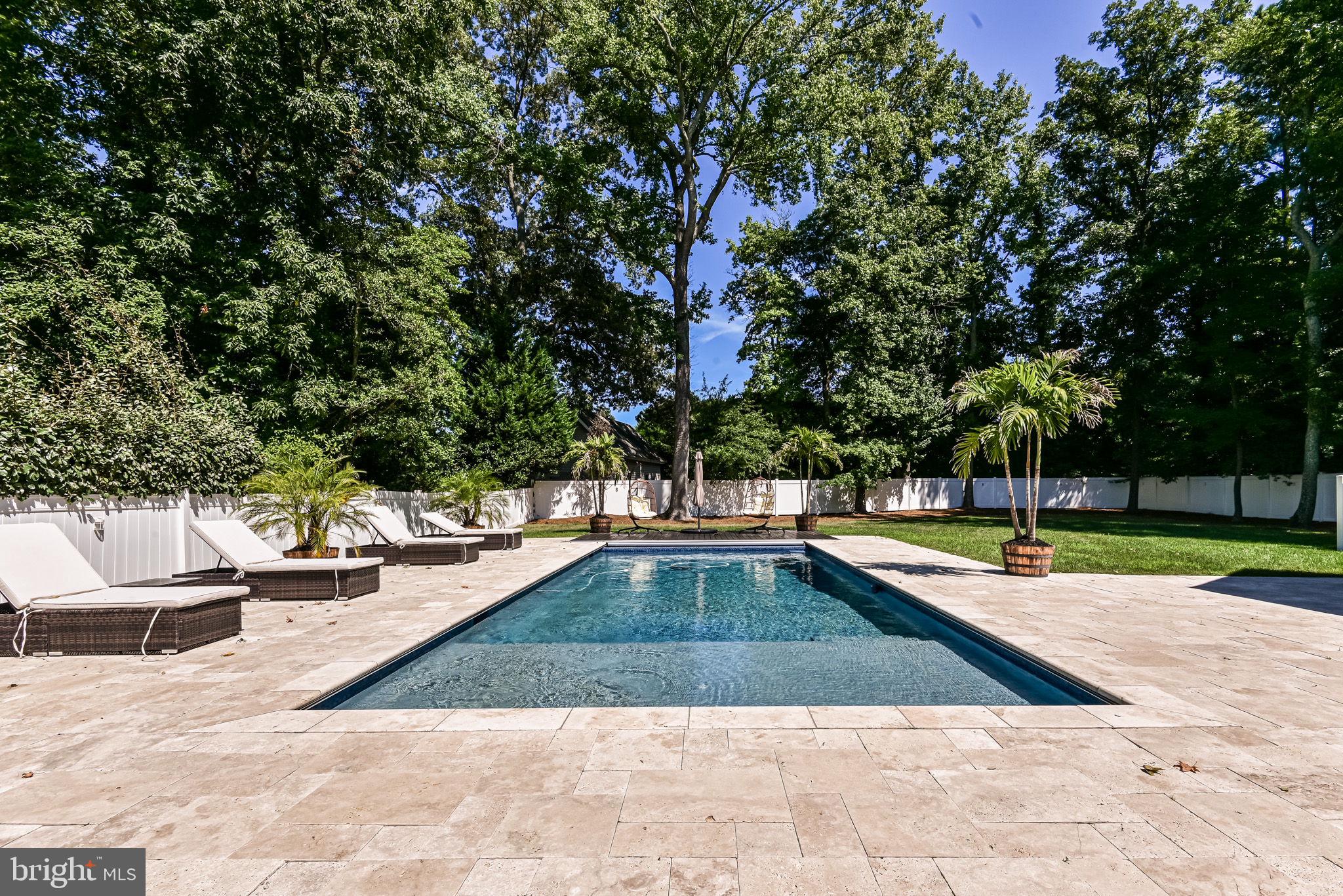 125 Cornwall Road Rehoboth Beach, DE 19971 - Photo 3 of 52 a view of a swimming pool with an outdoor seating