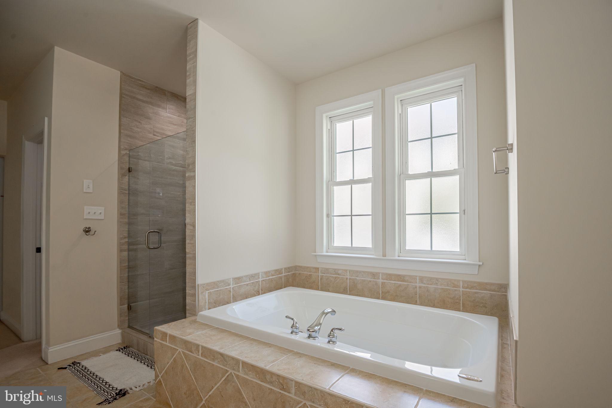125 Cornwall Road Rehoboth Beach, DE 19971 - Photo 31 of 52 a bathroom with a bathtub and window