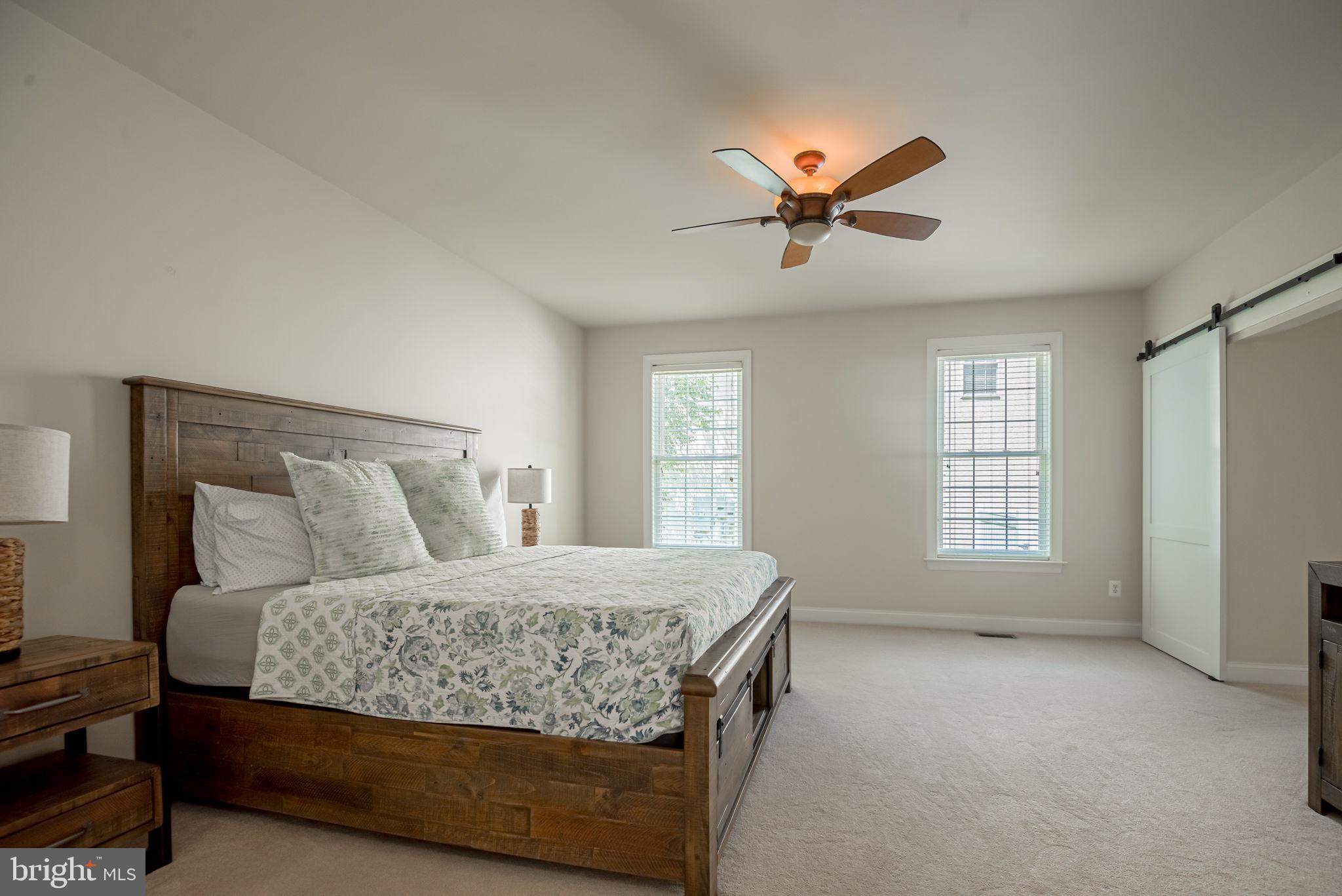 125 Cornwall Road Rehoboth Beach, DE 19971 - Photo 32 of 52 a bedroom with a large bed and a chandelier