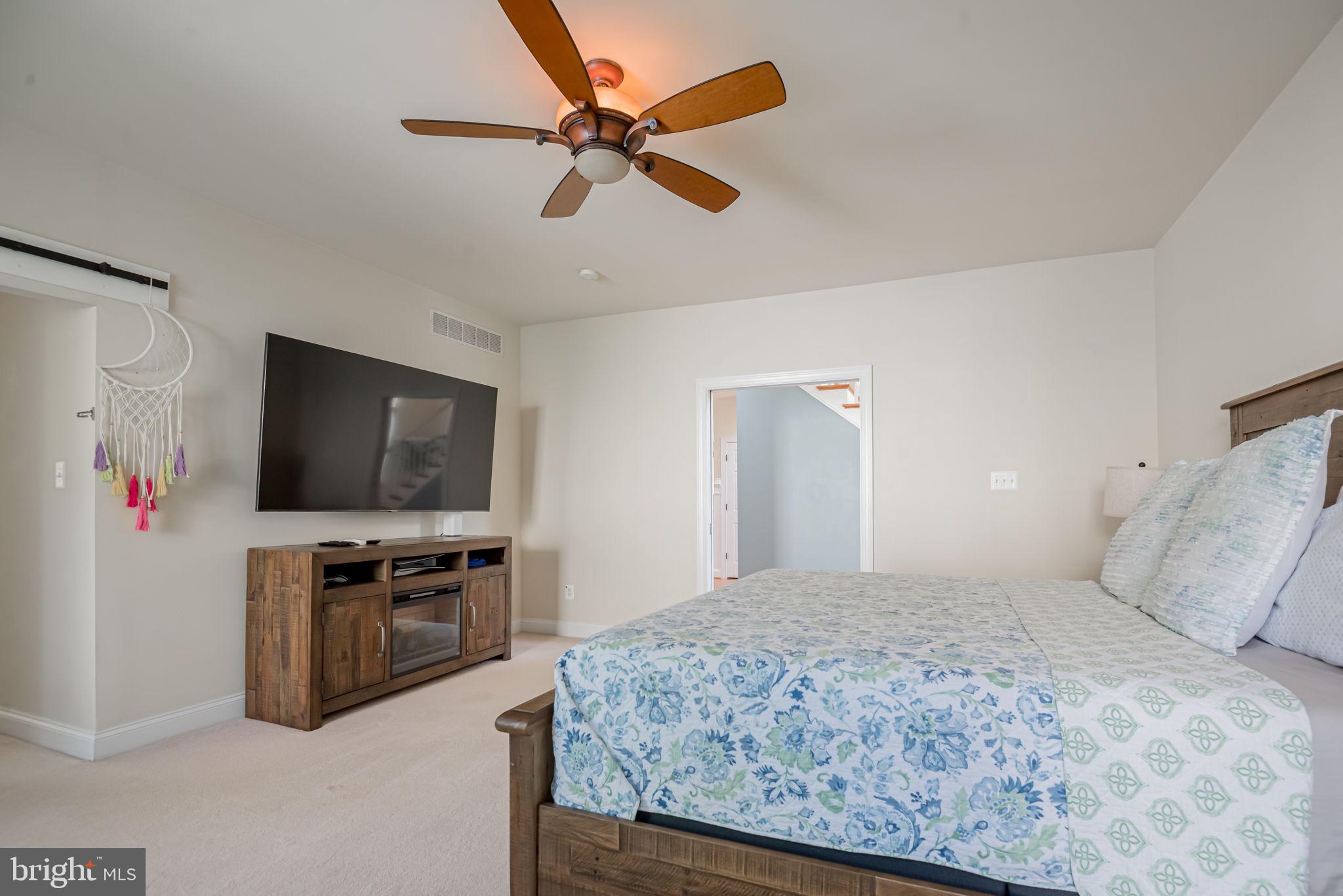 125 Cornwall Road Rehoboth Beach, DE 19971 - Photo 33 of 52 a bedroom with a bed and a flat screen tv