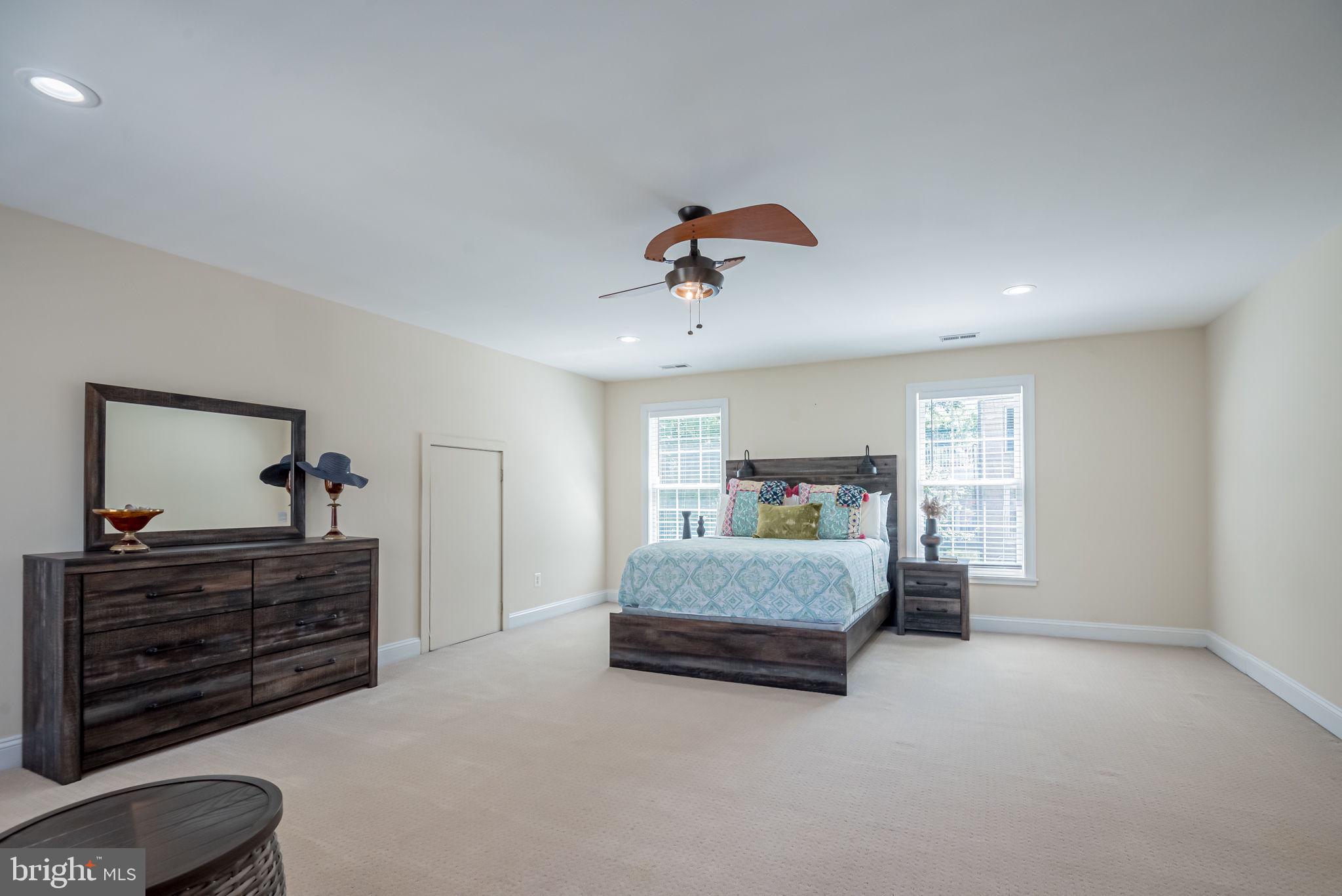125 Cornwall Road Rehoboth Beach, DE 19971 - Photo 38 of 52 a bedroom with a bed and a chandelier