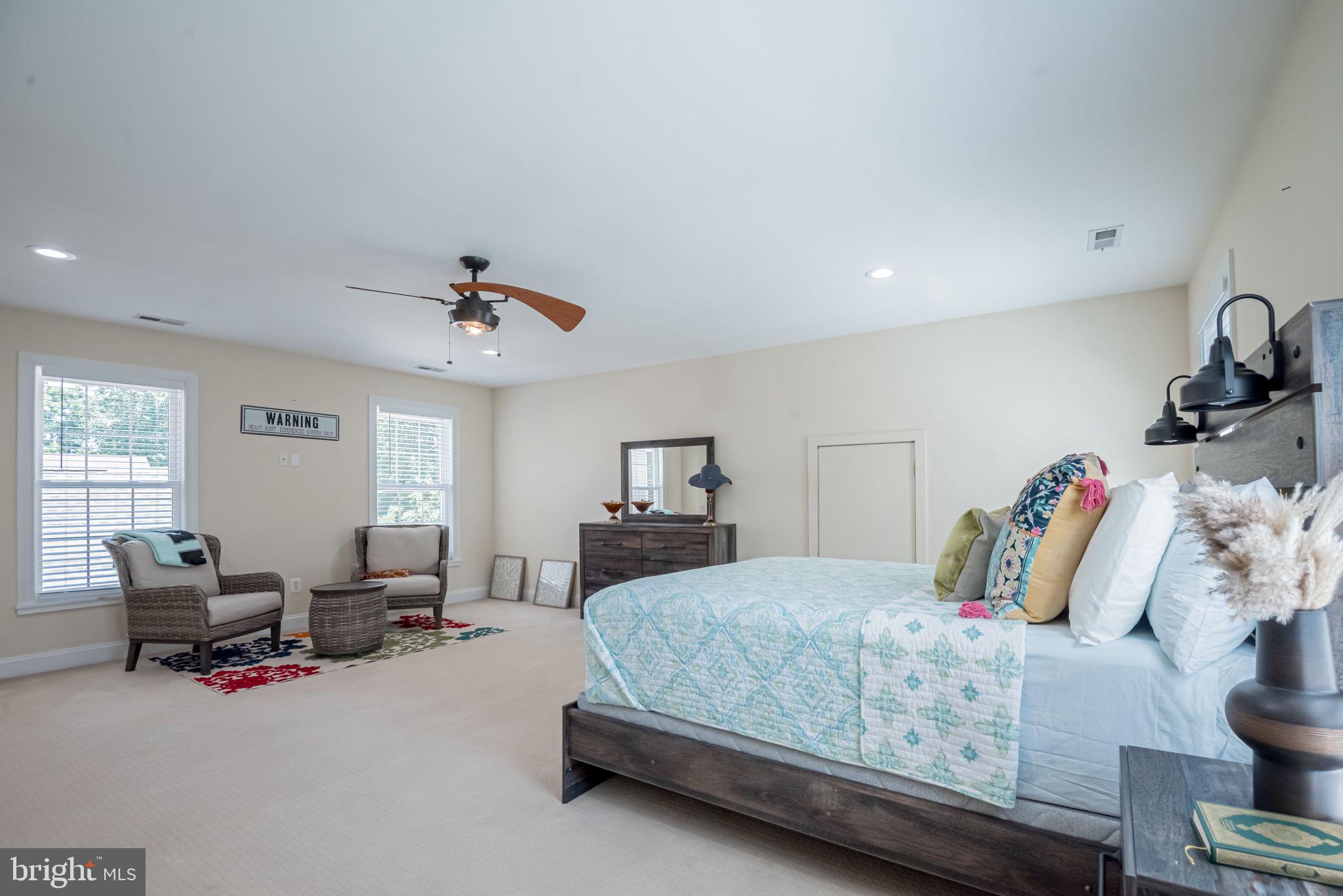 125 Cornwall Road Rehoboth Beach, DE 19971 - Photo 40 of 52 a bedroom with a bed gym equipment and a large window