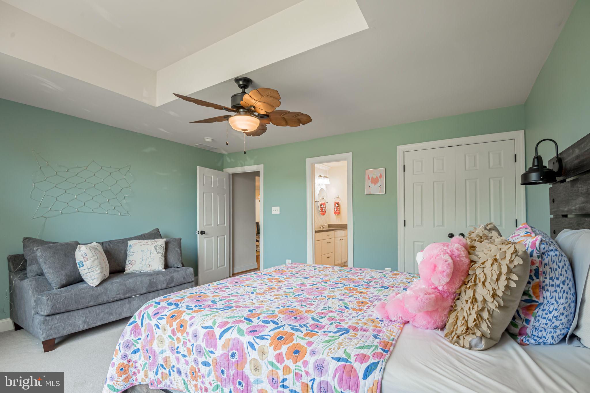 125 Cornwall Road Rehoboth Beach, DE 19971 - Photo 42 of 52 a bedroom with a bed and a chandelier