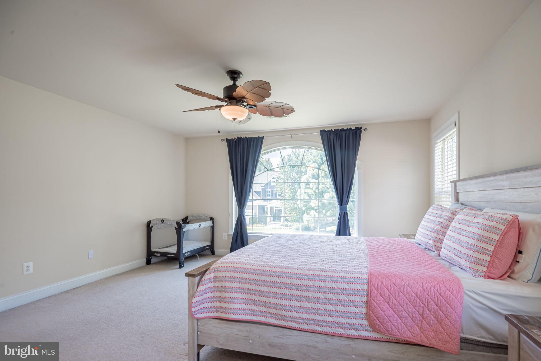 125 Cornwall Road Rehoboth Beach, DE 19971 - Photo 46 of 52 a bedroom with a bed and a chandelier