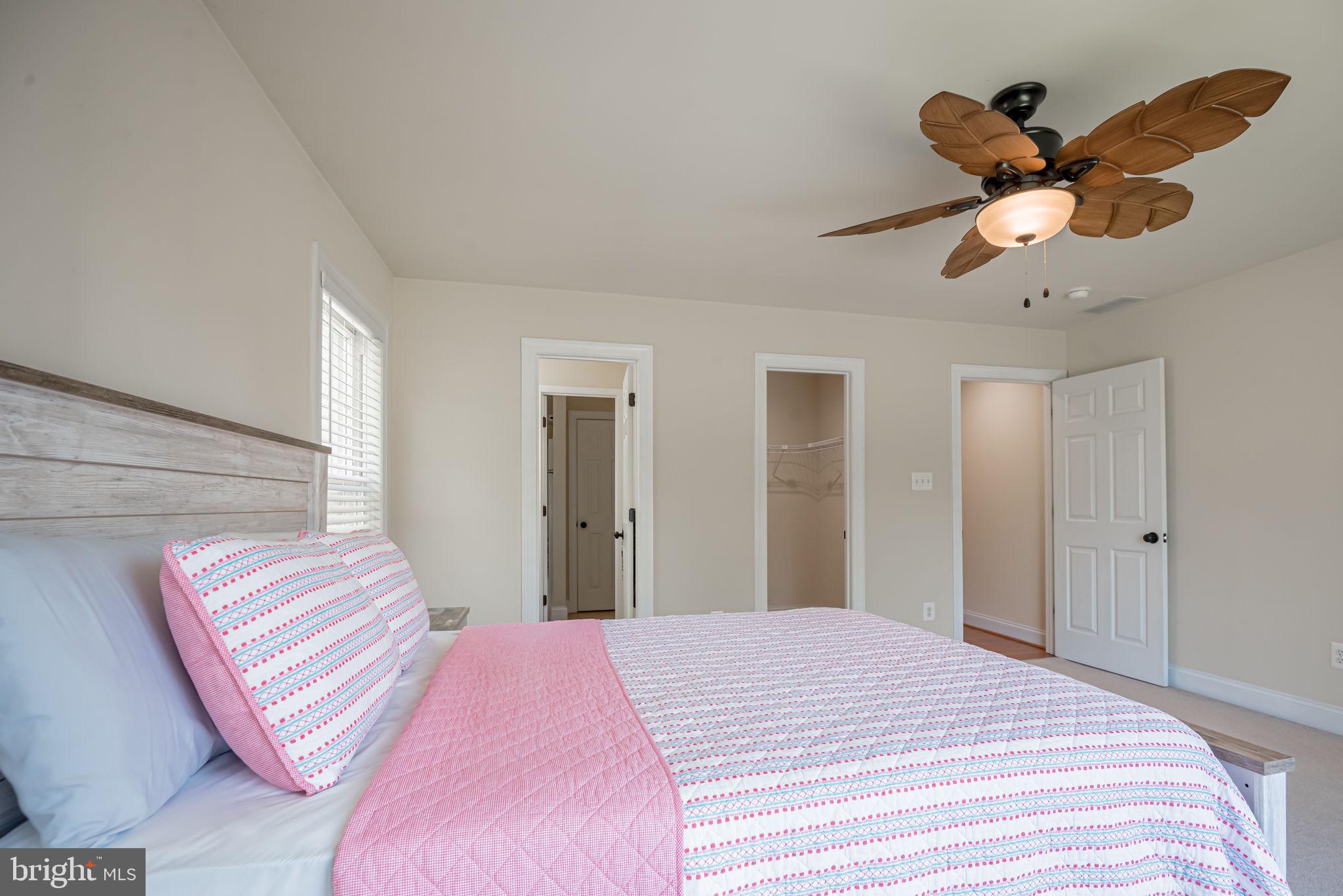 125 Cornwall Road Rehoboth Beach, DE 19971 - Photo 48 of 52 a bedroom with a bed and a chandelier