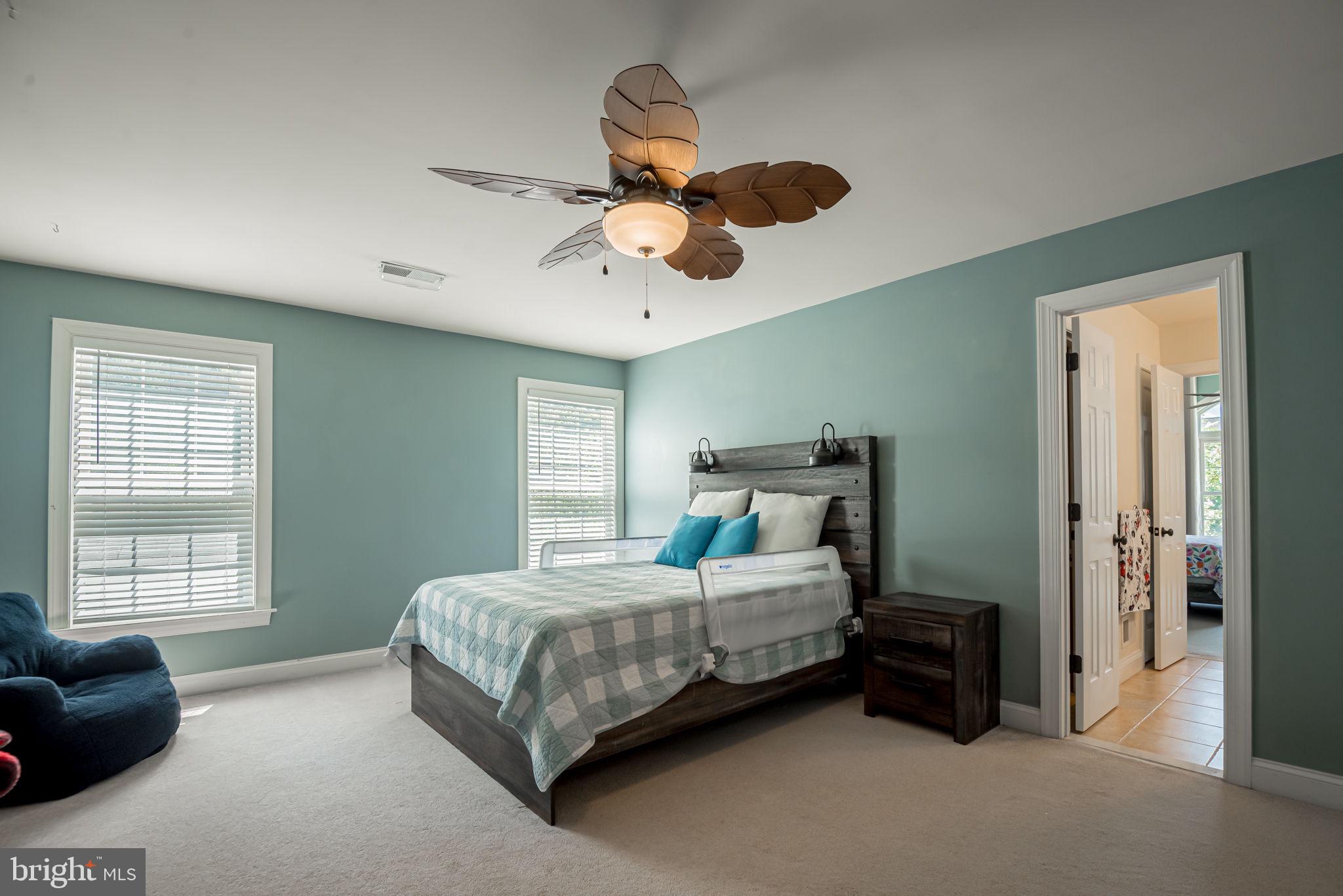 125 Cornwall Road Rehoboth Beach, DE 19971 - Photo 49 of 52 a bedroom with a bed chandelier and window