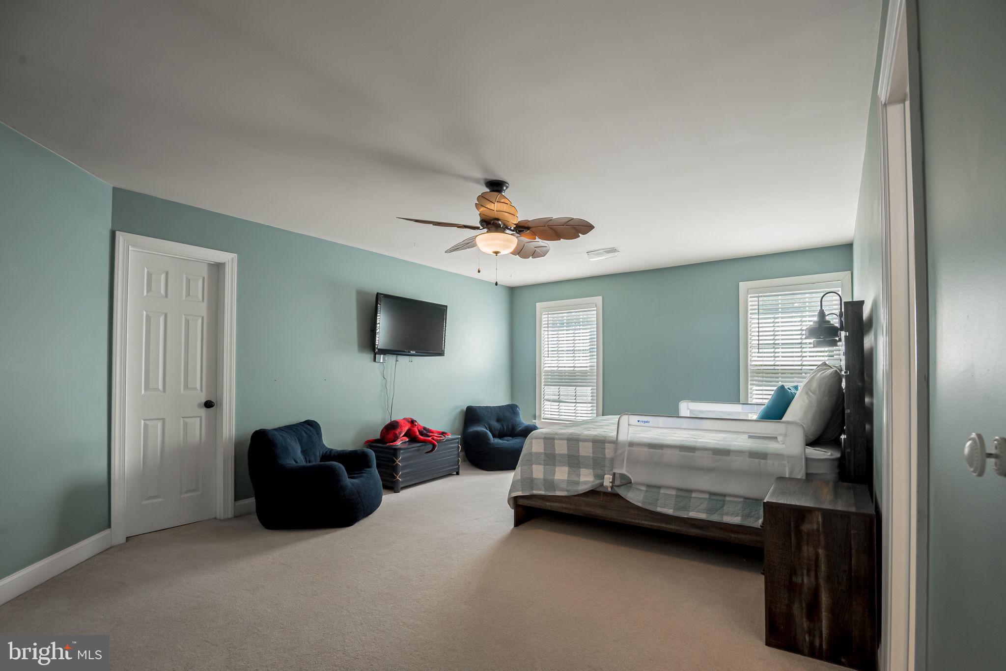 125 Cornwall Road Rehoboth Beach, DE 19971 - Photo 50 of 52 a bedroom with bed and a chandelier