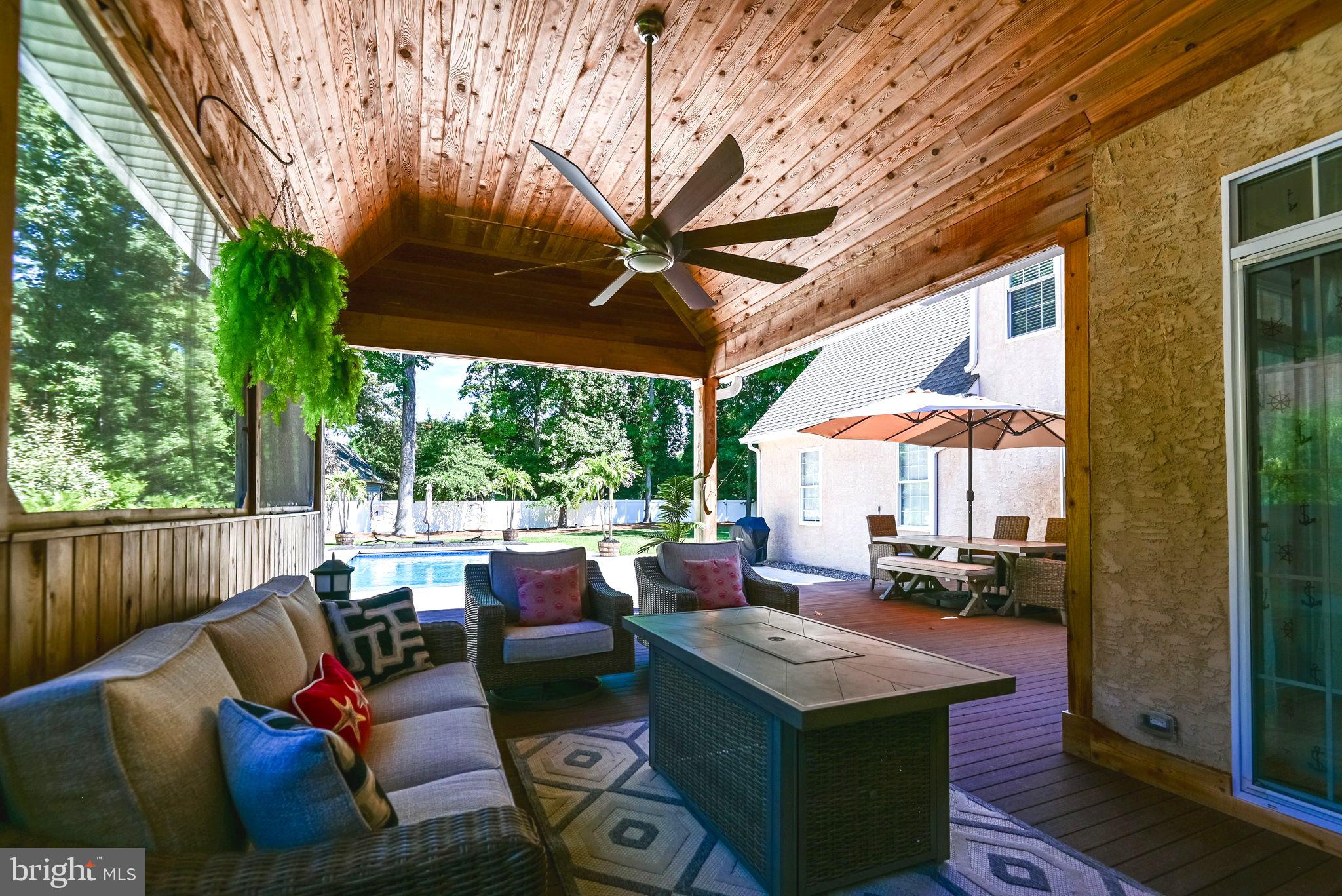 125 Cornwall Road Rehoboth Beach, DE 19971 - Photo 8 of 52 a outdoor space with patio the couches and a dining table with garden view