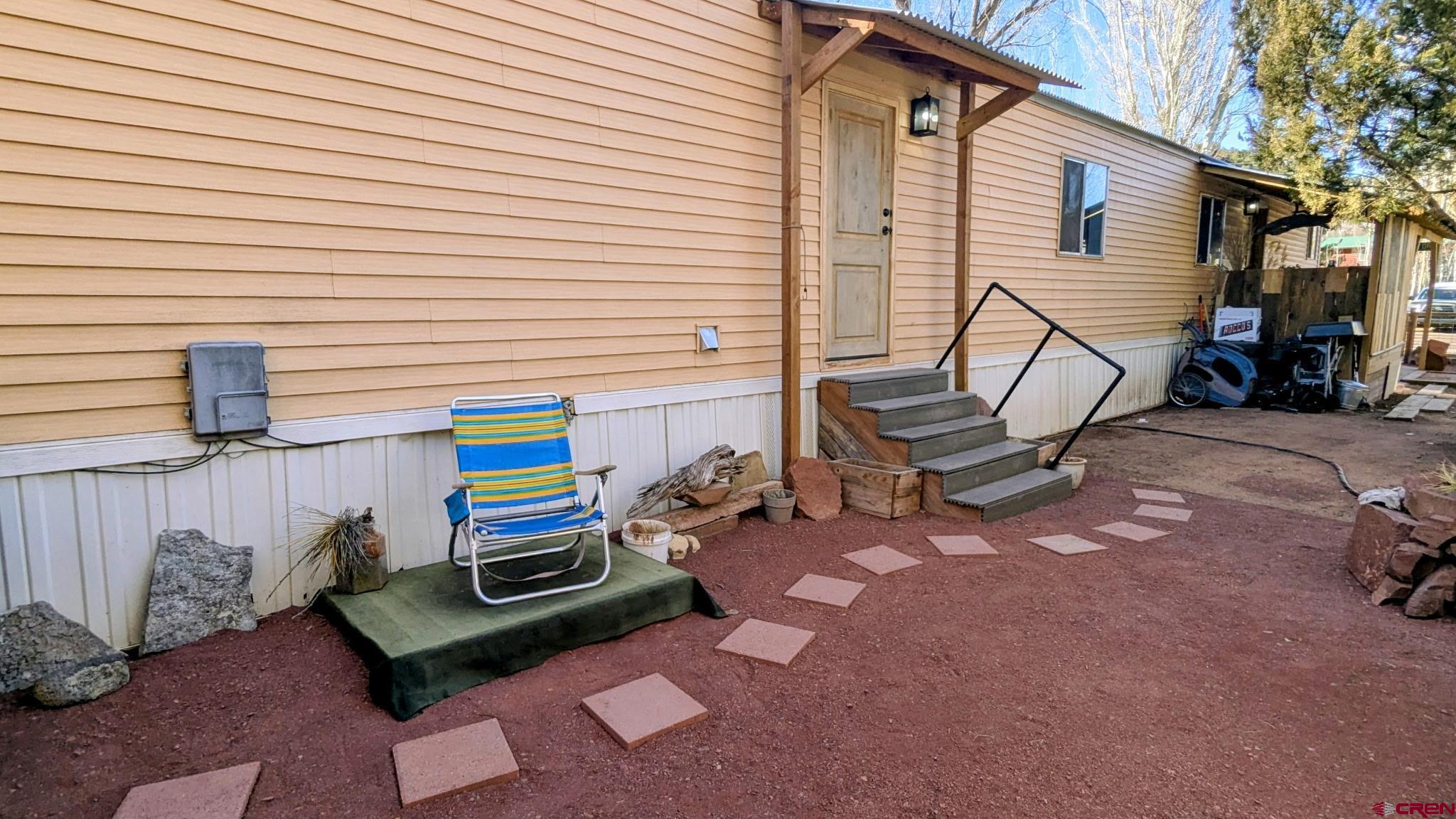 2403 County Road 203, Unit 44 Durango, CO 81301 - Photo 1 of 41 a backyard of a house with barbeque oven table and chairs