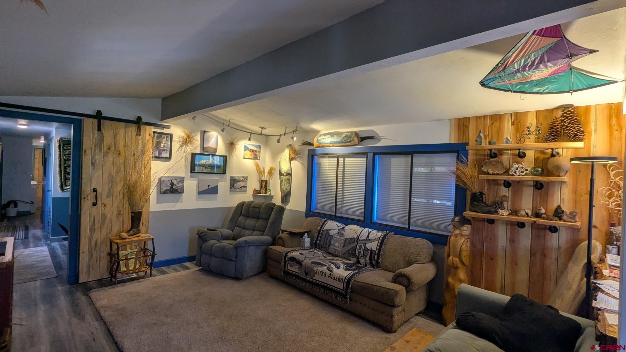 2403 County Road 203, Unit 44 Durango, CO 81301 - Photo 24 of 41 a living room with furniture a lamp and a large window