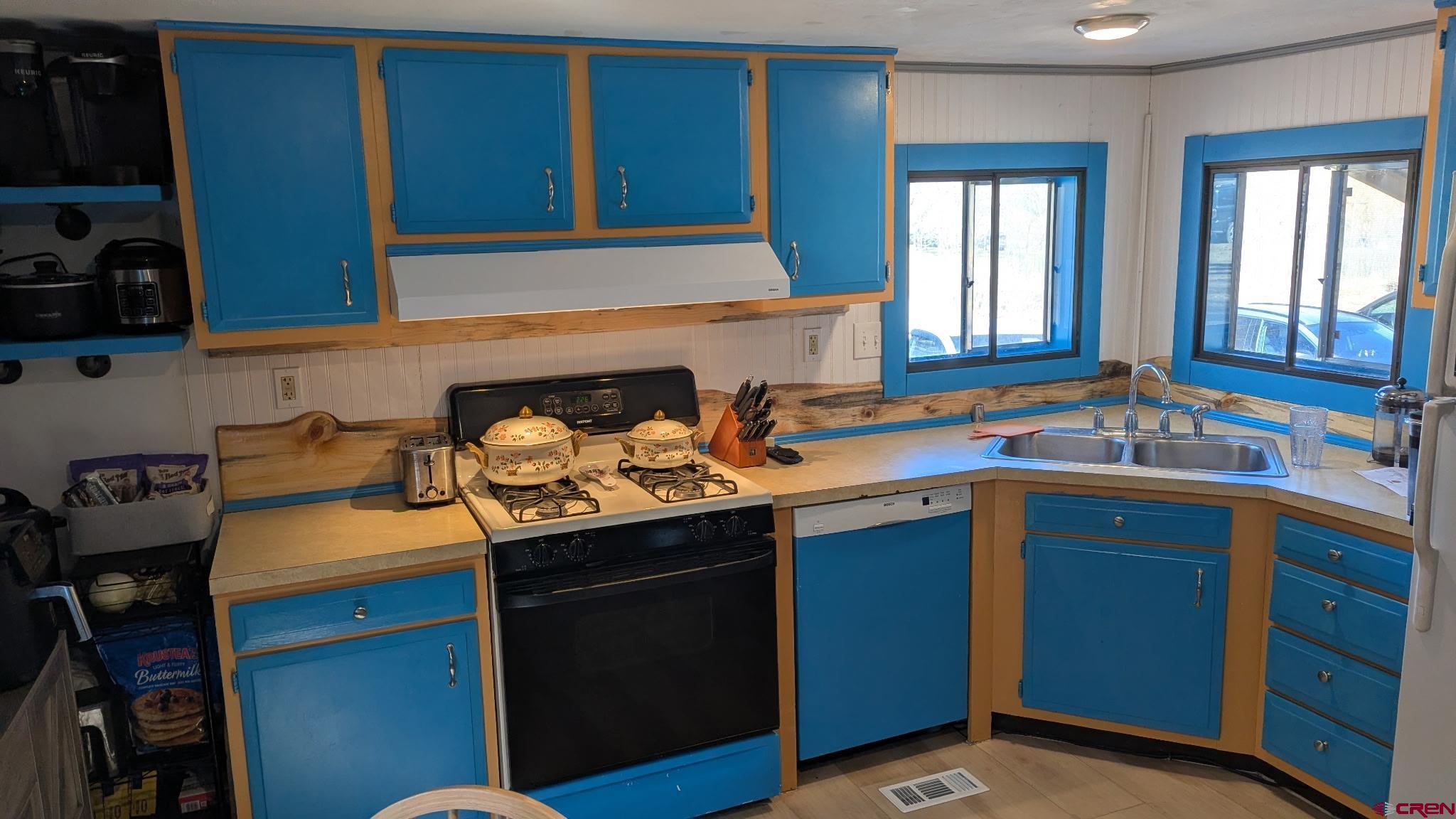 2403 County Road 203, Unit 44 Durango, CO 81301 - Photo 29 of 41 a kitchen with a sink stove and cabinets