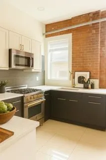 a kitchen with stainless steel appliances granite countertop a sink and a stove top oven with granite countertops