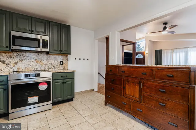 a kitchen with stainless steel appliances granite countertop a stove and a microwave