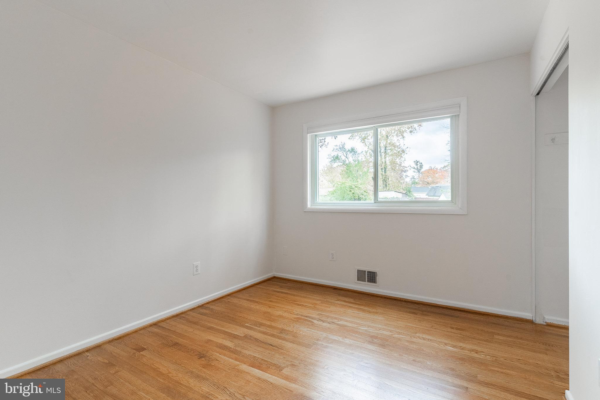 6609 Bowie Drive Springfield, VA 22150 - Photo 13 of 29 an empty room with wooden floor and windows