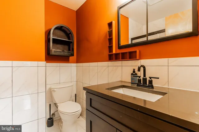 a bathroom with a sink a toilet and mirror