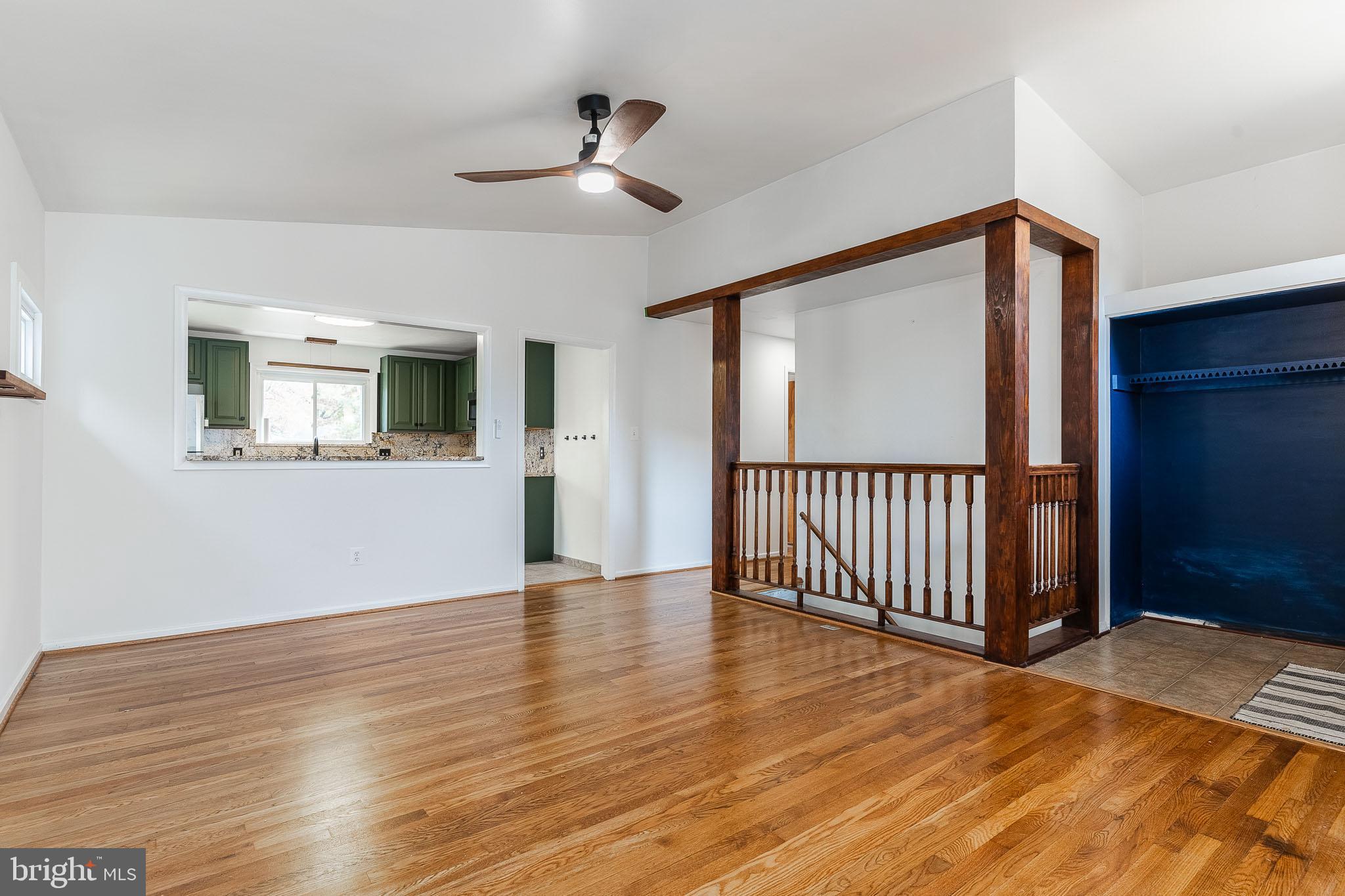 6609 Bowie Drive Springfield, VA 22150 - Photo 6 of 29 a view of a livingroom with wooden floor and white walls