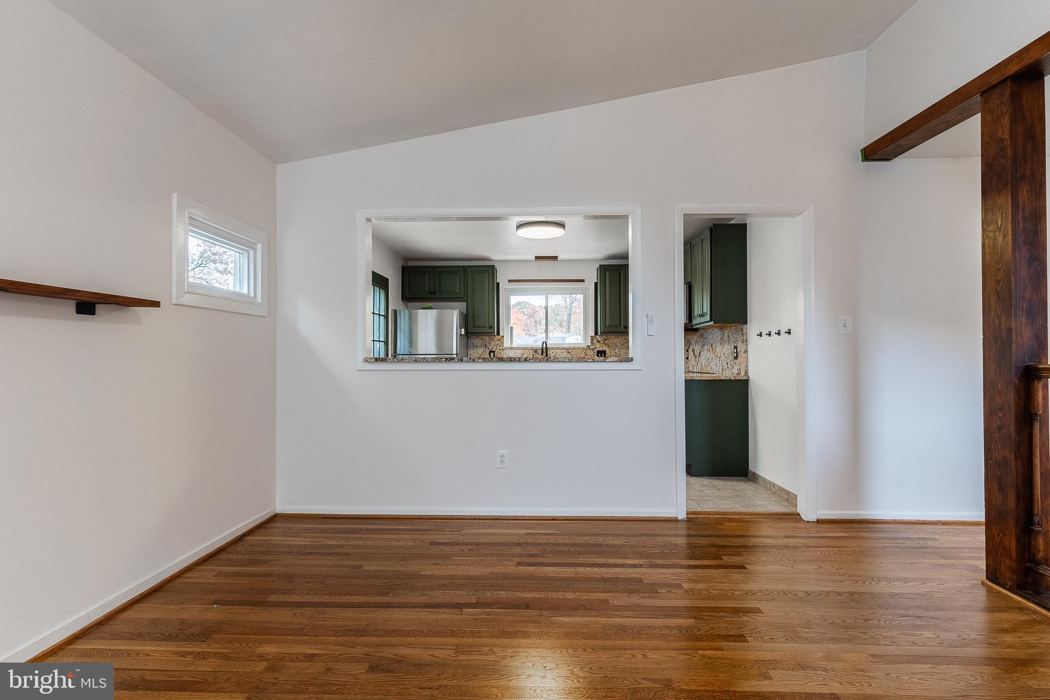 6609 Bowie Drive Springfield, VA 22150 - Photo 7 of 29 a view of a room with wooden floor and a window