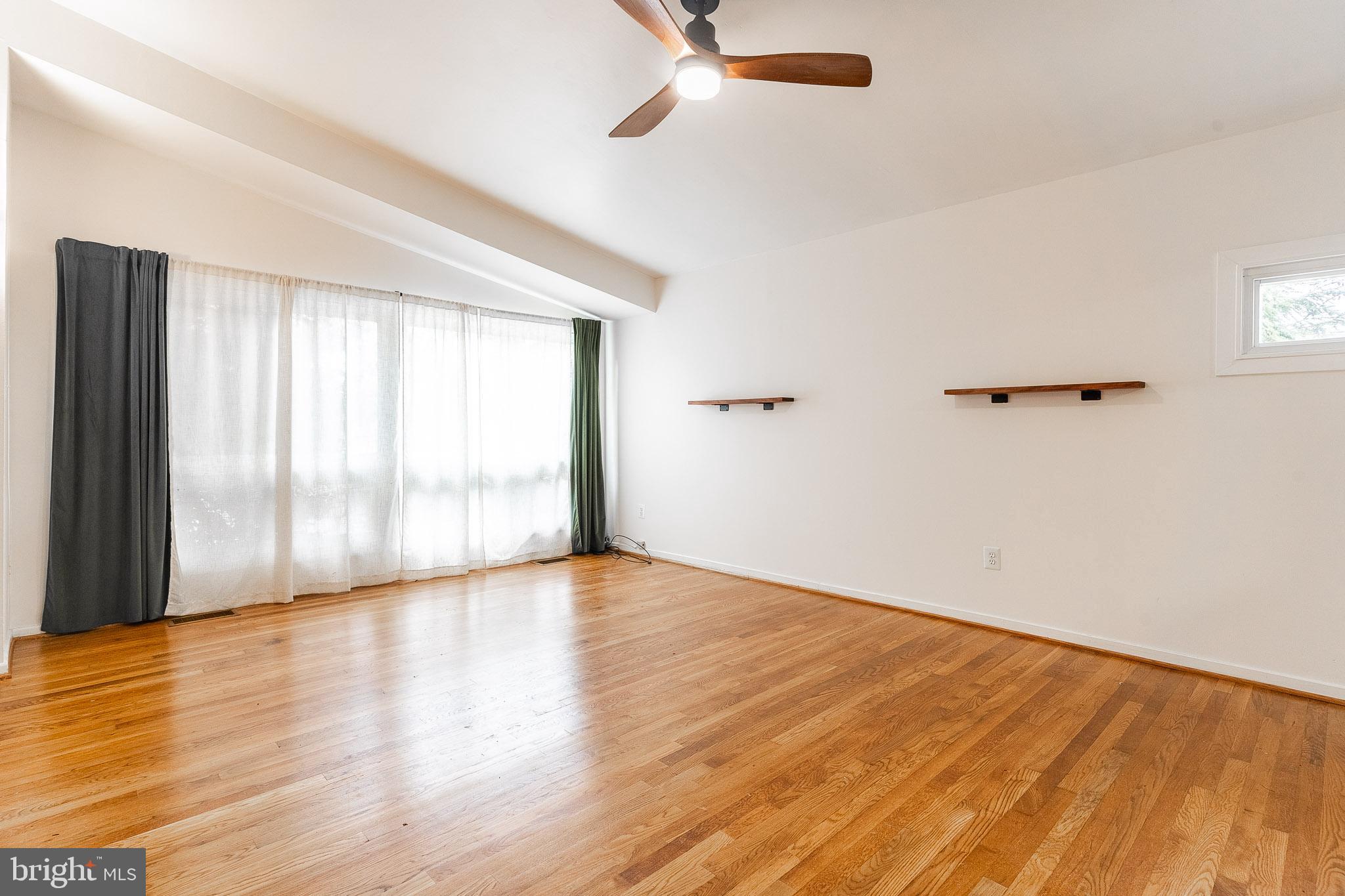 6609 Bowie Drive Springfield, VA 22150 - Photo 9 of 29 an empty room with wooden floor and windows