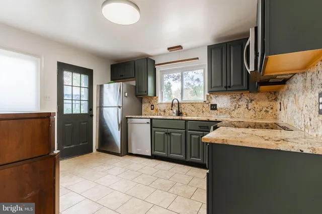 a kitchen with a sink appliances and cabinets