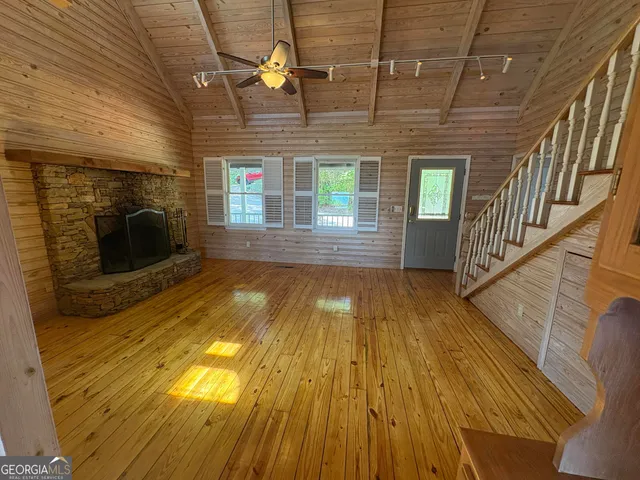 a view of hallway with wooden floor and fireplace