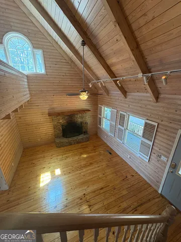 a dining room with a wooden table and chairs