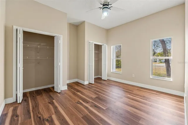 a view of balcony with a large window and wooden floor