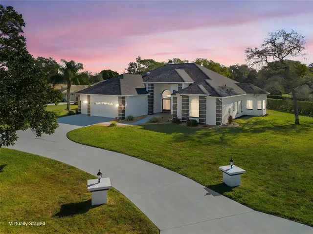 a spacious bathroom with a granite countertop double vanity sink a mirror and a bathtub