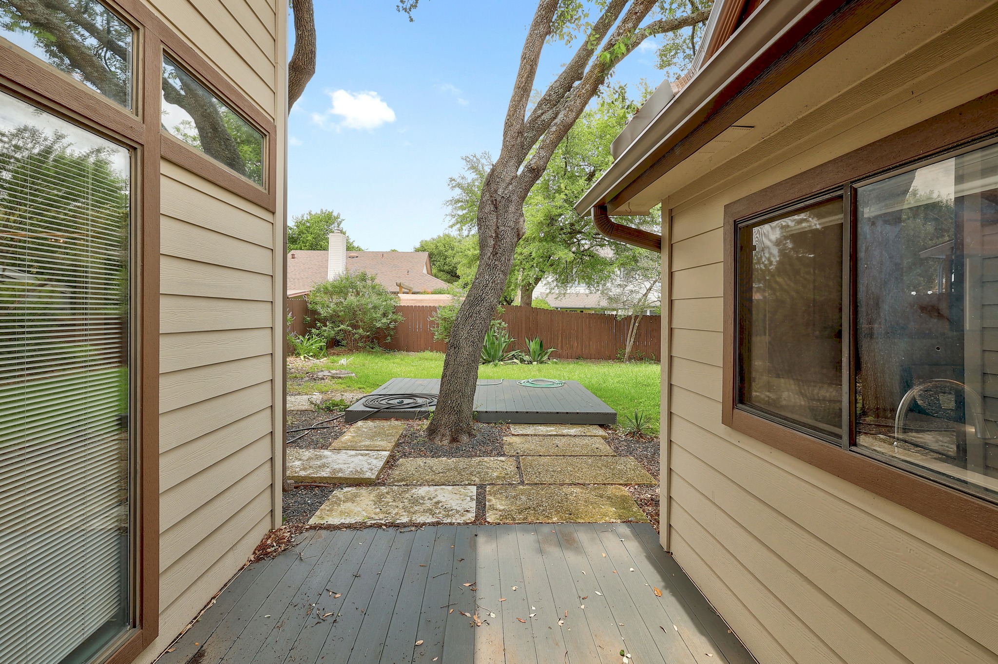 2202 Warfield Way Austin, TX 78728 - Photo 29 of 32 A tranquil outdoor space features a combination of decking and stone pathways, perfect for quiet enjoyment.