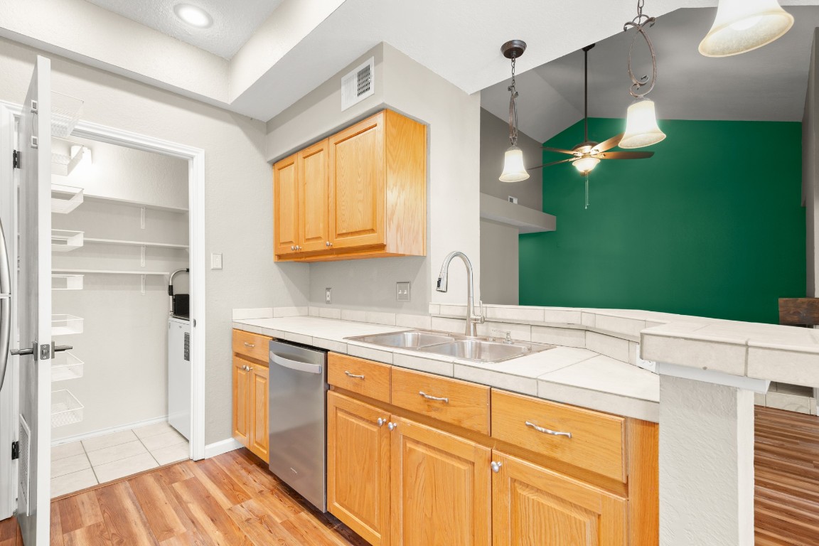 4711 Spicewood Springs Road, Unit 260 Austin, TX 78759 - Photo 12 of 20 a kitchen with a sink cabinets and a wooden floor