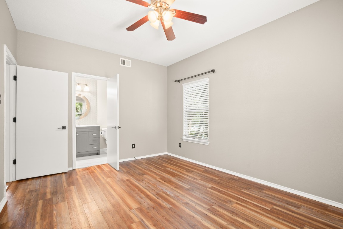 4711 Spicewood Springs Road, Unit 260 Austin, TX 78759 - Photo 13 of 20 wooden floor in an empty room with a window