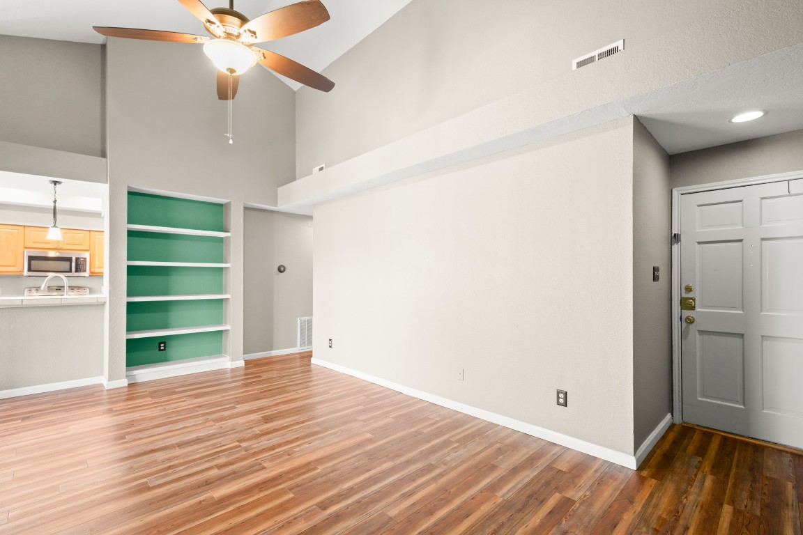 4711 Spicewood Springs Road, Unit 260 Austin, TX 78759 - Photo 7 of 20 a view of an empty room with a window and wooden floor