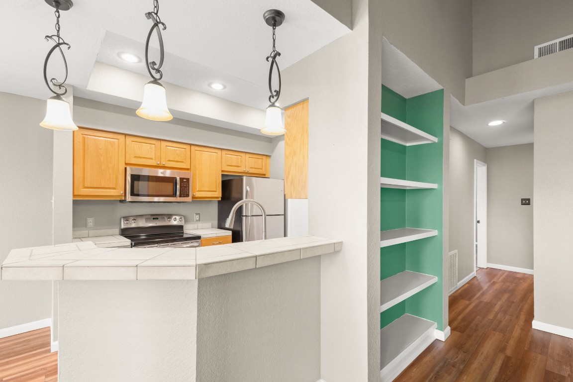 4711 Spicewood Springs Road, Unit 260 Austin, TX 78759 - Photo 9 of 20 a kitchen view of counter top space wooden floor and window