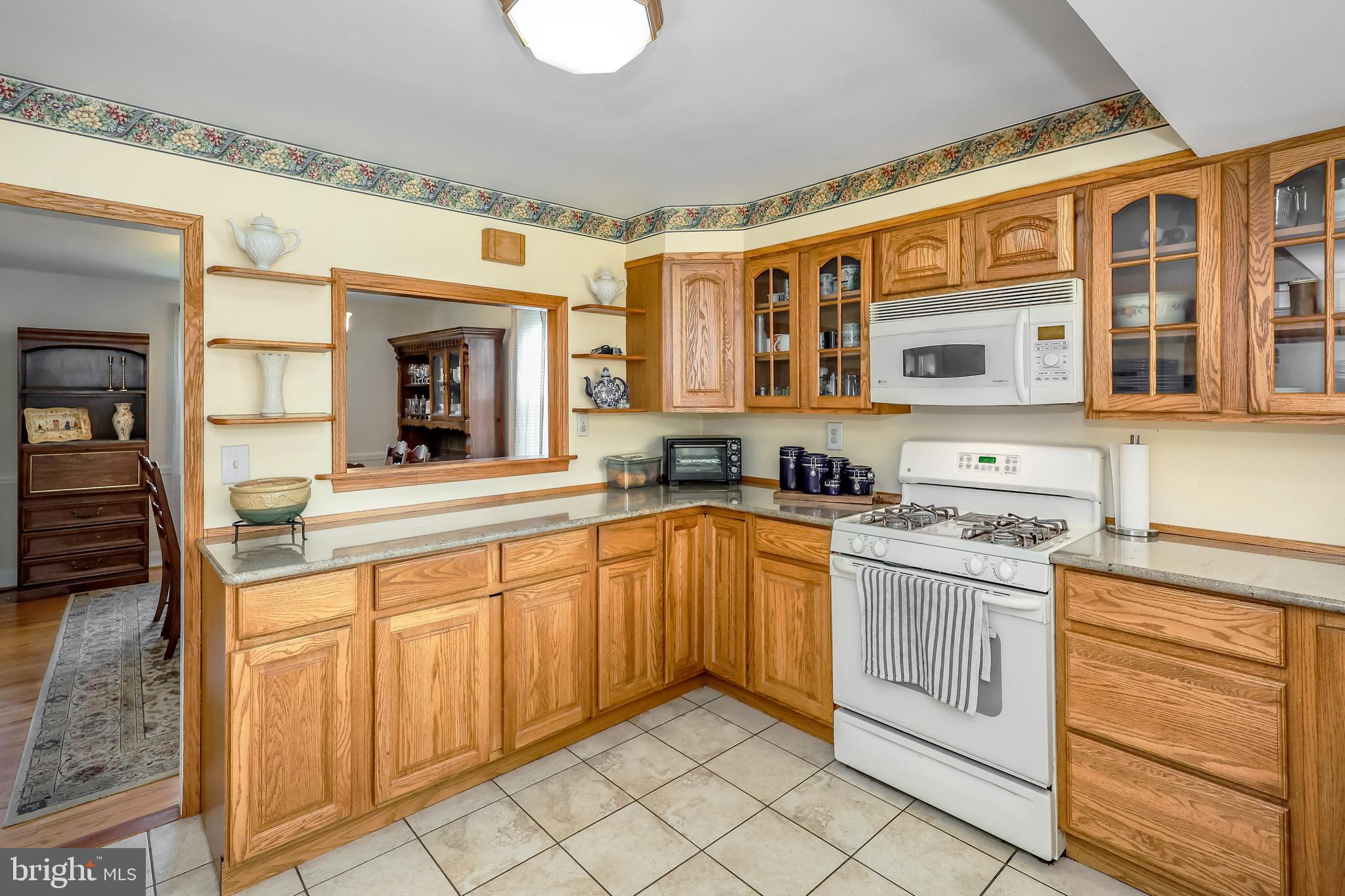 571 Rutherford Drive Springfield, PA 19064 - Photo 11 of 36 a large kitchen with stainless steel appliances granite countertop a stove and a sink