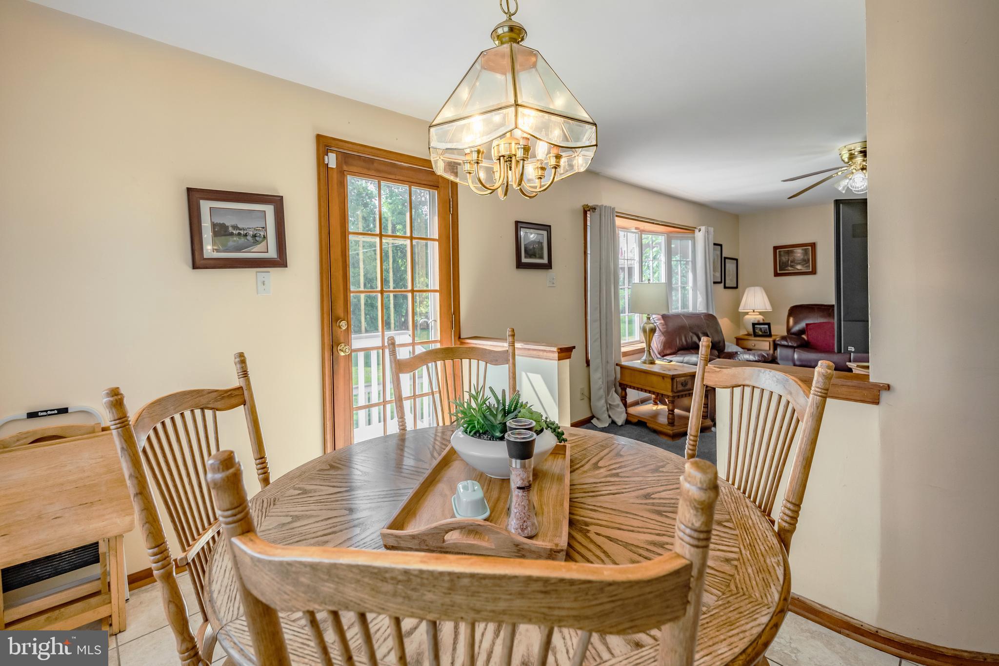 571 Rutherford Drive Springfield, PA 19064 - Photo 17 of 36 a view of a dining room with furniture a chandelier and wooden floor