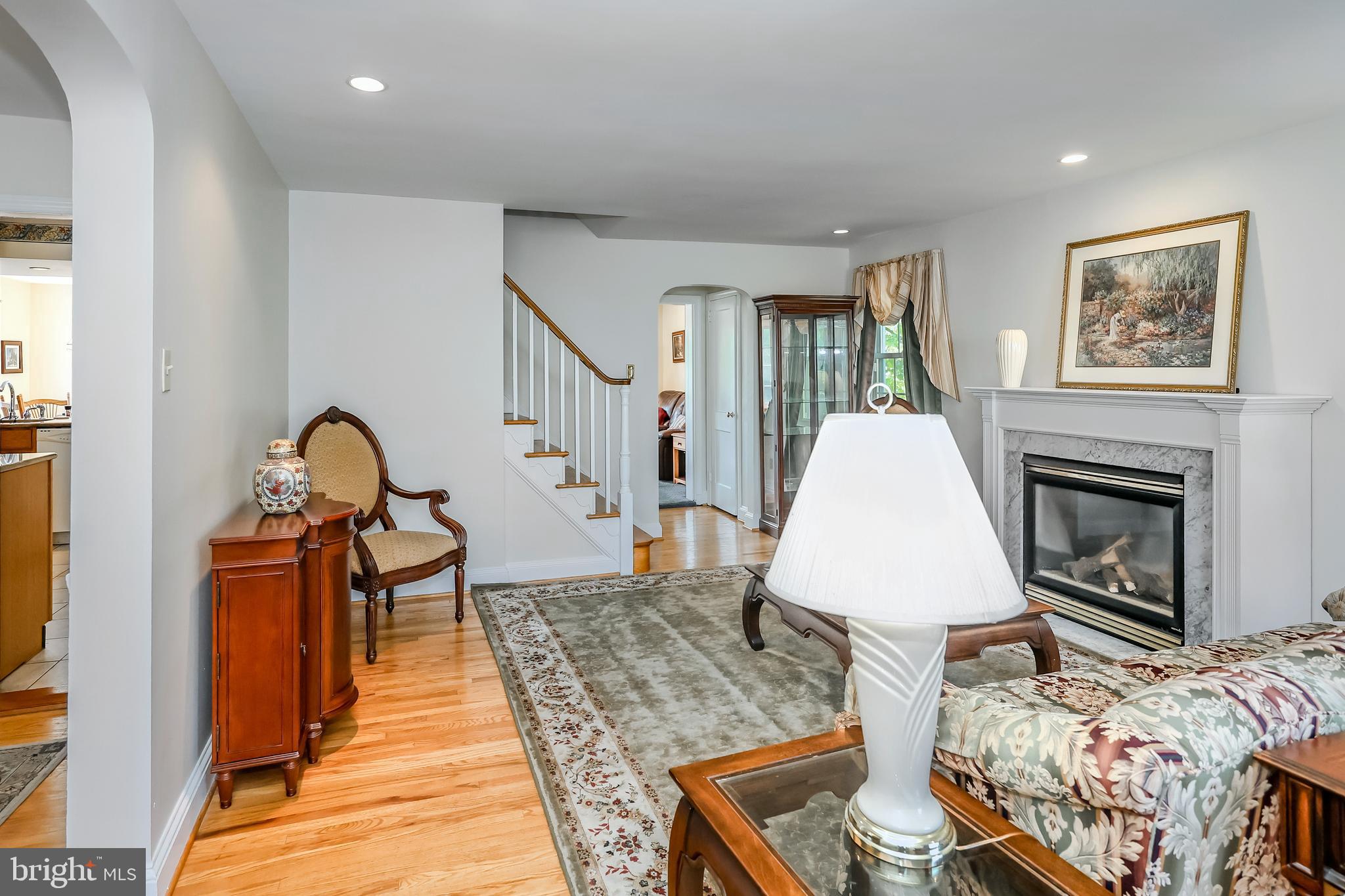571 Rutherford Drive Springfield, PA 19064 - Photo 5 of 36 a view of a livingroom with furniture a fireplace wooden floor and windows