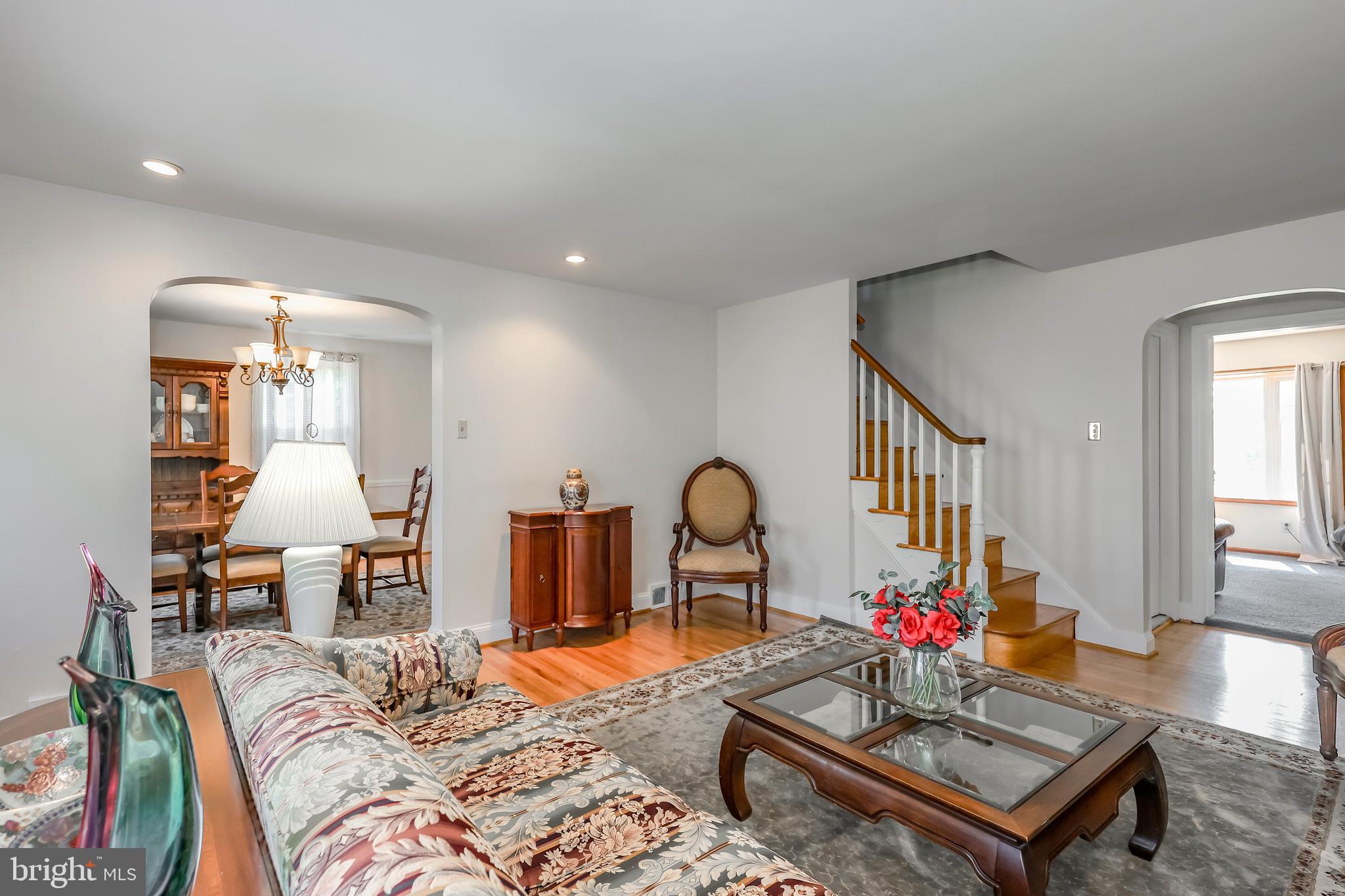 571 Rutherford Drive Springfield, PA 19064 - Photo 6 of 36 a living room with furniture a rug and a chandelier