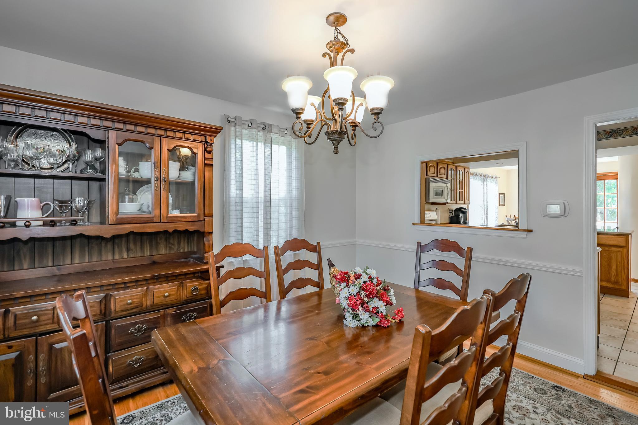 571 Rutherford Drive Springfield, PA 19064 - Photo 8 of 36 a view of a dining room with furniture a chandelier and wooden floor