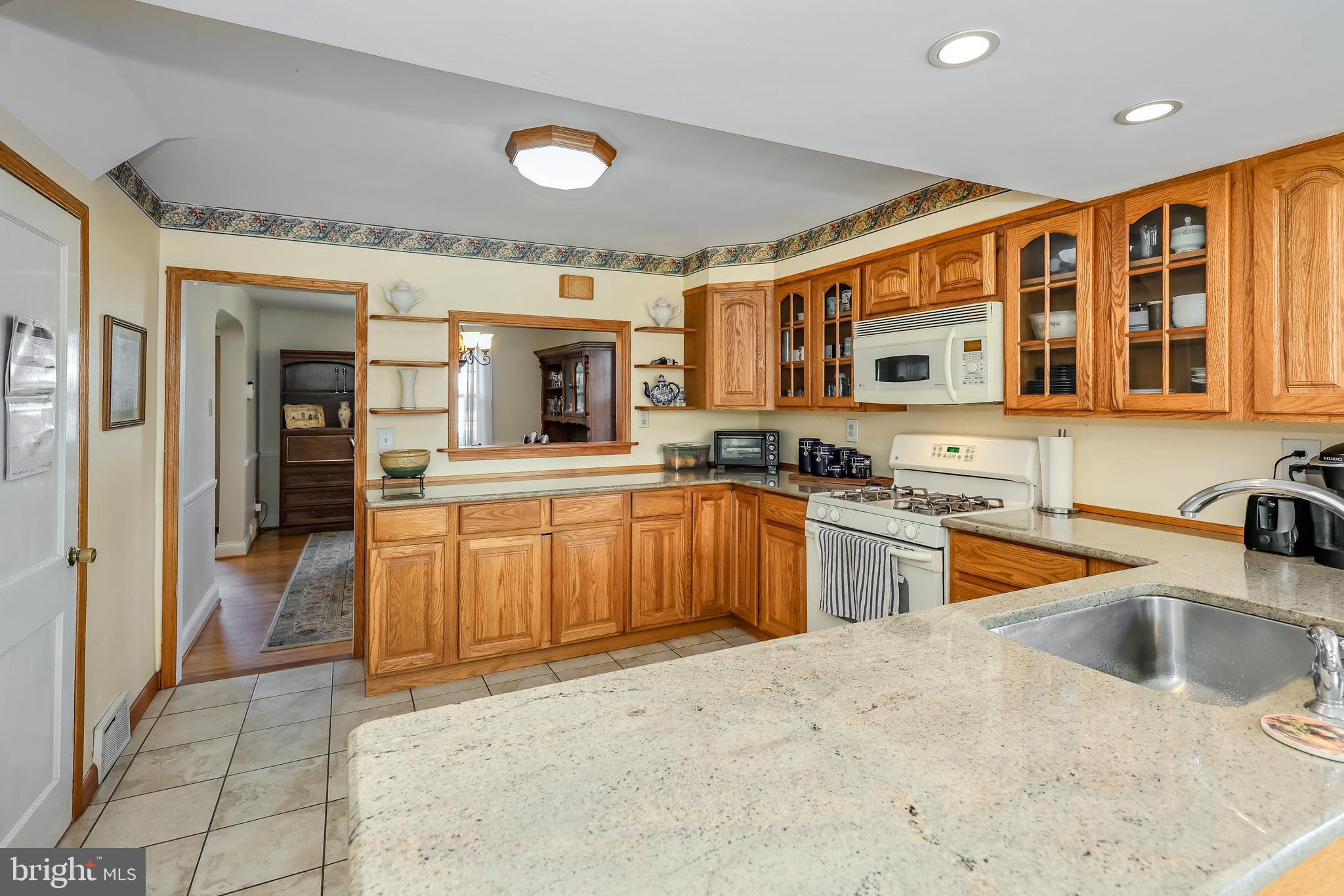 571 Rutherford Drive Springfield, PA 19064 - Photo 10 of 36 a large kitchen with stainless steel appliances granite countertop a sink and cabinets