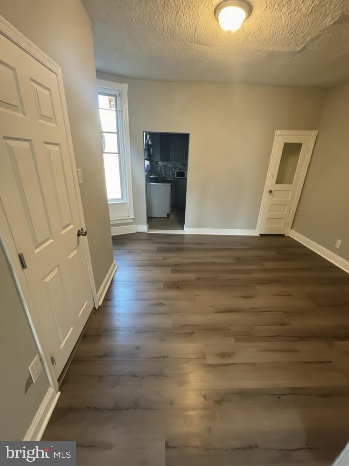 5807 Master Street Philadelphia, PA 19131 - Photo 5 of 21 a view of an empty room with wooden floor and a window