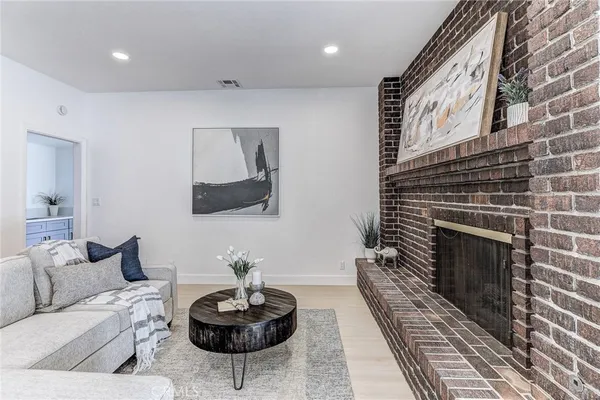 a room with white cabinets and clock on the wall