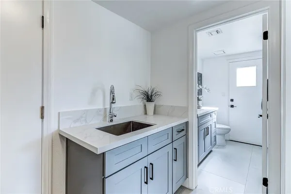 a kitchen with white cabinets and refrigerator