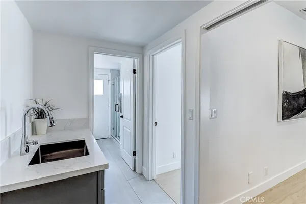 a view of a hallway with wooden floor and closet