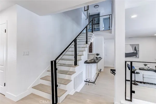 a kitchen with stainless steel appliances granite countertop a sink a stove and a refrigerator