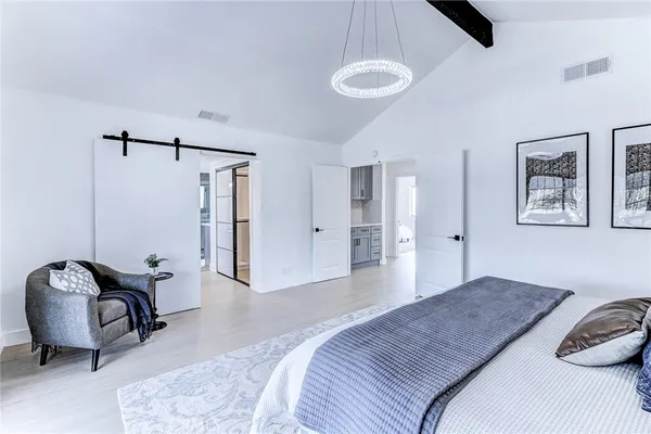 a view of a hallway with a glass door and shower