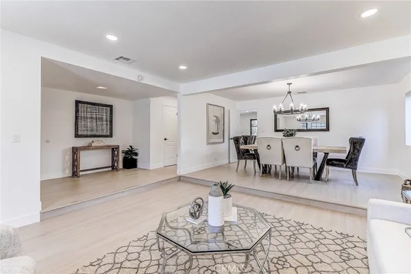a living room with furniture and a dining table