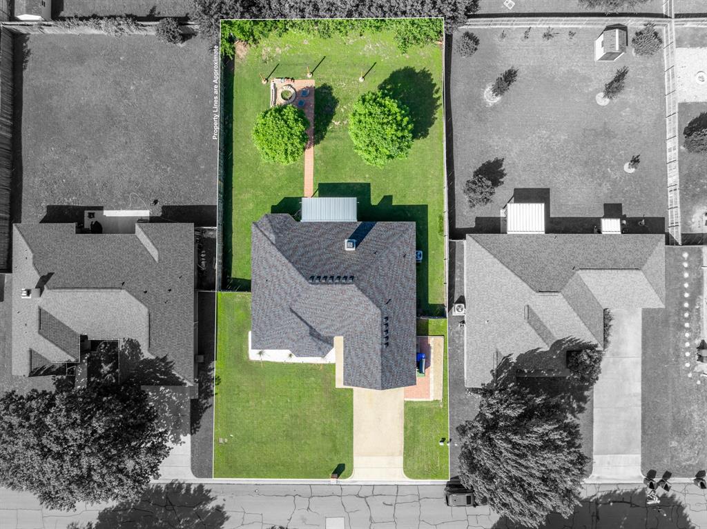 10512 Whitney Trace Drive Waco, TX 76708 - Photo 39 of 39 Property featuring a dark shingle roof, a generously sized green lawn, and a light-colored driveway