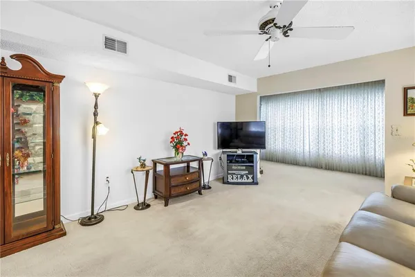 a view of a livingroom with furniture and a flat screen tv