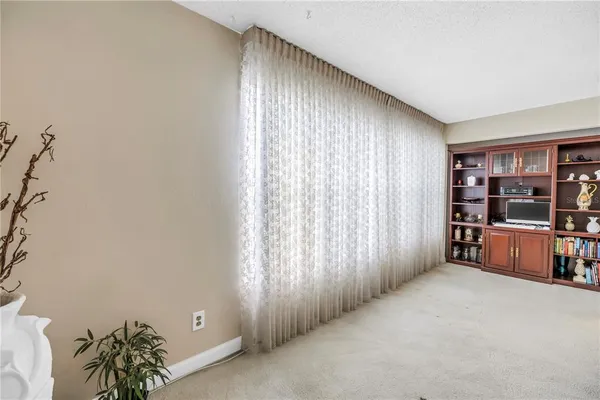 an empty room with window and closet