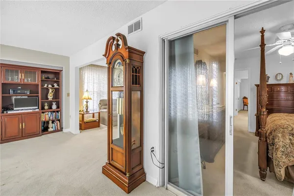 a view of elevator with hallway and glass door