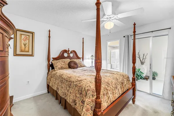 a bedroom with a large bed and a chandelier
